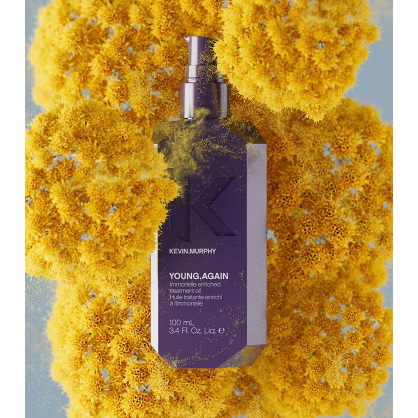 YOUNG.AGAIN oil bottle surrounded by yellow flowers with powder effect YOUNG.AGAIN oil bottle surrounded by yellow flowers with powder effect